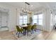 Dining room with hardwood floors, bright windows with sheer curtains, and an elegant chandelier at 1892 Ponsonby Dr, Westfield, IN 46074