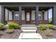 Inviting front porch with brick accents, decorative columns, and landscaping at 1892 Ponsonby Dr, Westfield, IN 46074