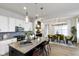 Modern kitchen featuring a large island with seating, stainless steel appliances, and stylish pendant lighting at 1892 Ponsonby Dr, Westfield, IN 46074