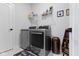 Laundry room featuring modern appliances, shelving, and decorative touches at 1892 Ponsonby Dr, Westfield, IN 46074