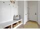 Mudroom featuring a built-in bench with storage, coat hooks, and a neutral colored rug, perfect for organization at 1892 Ponsonby Dr, Westfield, IN 46074