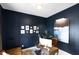 This home office features dark blue walls, a modern desk, and comfortable leather sofa at 1892 Ponsonby Dr, Westfield, IN 46074