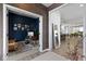 Stylish home office with dark blue walls, wood desk and leather sofa at 1892 Ponsonby Dr, Westfield, IN 46074