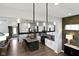 Spacious open floor plan featuring a kitchen island with seating, stainless steel appliances and modern lighting fixtures at 1892 Ponsonby Dr, Westfield, IN 46074