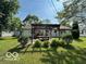 Backyard featuring a pergola with a picnic table and lush landscaping at 1919 Manor Dr, Lebanon, IN 46052