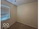 This cozy bedroom features neutral walls, a window with blinds, and comfortable carpeting at 1919 Manor Dr, Lebanon, IN 46052