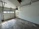 Empty Garage with a white garage door and concrete floor at 1919 Manor Dr, Lebanon, IN 46052