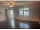 Open living room with dark hardwood floors, a ceiling fan, and natural light at 1919 Manor Dr, Lebanon, IN 46052