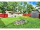 The backyard features a fire pit and storage shed, perfect for outdoor gatherings and storage at 217 W Burnside Ave, Fairland, IN 46126