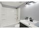 This bathroom features a shower-tub combo, a black vanity, and modern lighting at 217 W Burnside Ave, Fairland, IN 46126