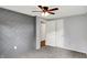 This cozy bedroom has light gray walls, a fan, and a statement textured wall at 217 W Burnside Ave, Fairland, IN 46126