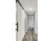 Hallway featuring modern flooring, fresh paint, and built-in storage for functionality and style at 217 W Burnside Ave, Fairland, IN 46126