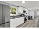 Modern kitchen featuring stainless steel appliances, sleek countertops, and ample storage in white cabinets at 217 W Burnside Ave, Fairland, IN 46126