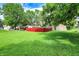 View of the yard with a spacious lawn, mature trees, and a storage shed at 217 W Burnside Ave, Fairland, IN 46126