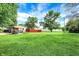 Expansive, green lawn with mature trees and a quaint house offers outdoor space and curb appeal at 217 W Burnside Ave, Fairland, IN 46126