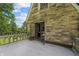 Balcony with stone siding, arched cement railing, an open doorway, and a view to the trees at 2421 W 39Th St, Indianapolis, IN 46228