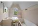Bathroom in need of renovation with vintage sink, bathtub, and window at 2421 W 39Th St, Indianapolis, IN 46228