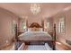 A bedroom with a four-poster bed, a chandelier, hardwood floors and two windows at 2421 W 39Th St, Indianapolis, IN 46228