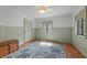 A bright bedroom with painted wainscoting, hardwood floors and a colorful area rug at 2421 W 39Th St, Indianapolis, IN 46228