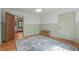 Bedroom featuring painted wainscoting, a colorful area rug, and wood flooring at 2421 W 39Th St, Indianapolis, IN 46228