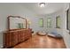 Bedroom with hardwood floors, large dresser and three windows allowing natural light at 2421 W 39Th St, Indianapolis, IN 46228