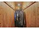 Walk-in cedar closet with wooden walls, hanging rods and luggage at 2421 W 39Th St, Indianapolis, IN 46228