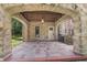 A covered patio featuring stone arches, a brick floor and access to the home at 2421 W 39Th St, Indianapolis, IN 46228