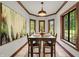 Dining room featuring a dining table illuminated by a pendant lamp and surrounded by large windows at 2421 W 39Th St, Indianapolis, IN 46228