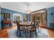 Elegant dining room featuring hardwood floors, blue walls, chandelier, and arched doors leading to the yard at 2421 W 39Th St, Indianapolis, IN 46228