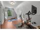 Bright exercise room with hardwood floors, a modern peloton bike and large windows at 2421 W 39Th St, Indianapolis, IN 46228