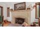 Close-up view of the carved stone fireplace with a painting and decorative objects on the mantle at 2421 W 39Th St, Indianapolis, IN 46228