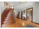 Grand foyer showcasing the hardwood staircase, decorative details, and access to various rooms at 2421 W 39Th St, Indianapolis, IN 46228