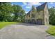A grand home featuring an attached three-car garage with arched entryways and a large driveway at 2421 W 39Th St, Indianapolis, IN 46228