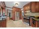 Well-lit kitchen with stainless steel appliances and dark wood cabinets at 2421 W 39Th St, Indianapolis, IN 46228