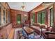 Elegant living room featuring wood-paneled walls, large windows, and classic furnishings at 2421 W 39Th St, Indianapolis, IN 46228