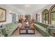 Open living room featuring hardwood floors, fireplace, and arched doorways leading to other parts of the home at 2421 W 39Th St, Indianapolis, IN 46228
