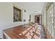 Sunroom with a stone floor, large windows, wooden table, and an open doorway to the interior of the house at 2421 W 39Th St, Indianapolis, IN 46228