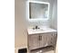Modern bathroom featuring a floating vanity with white countertop and a backlit mirror at 2423 E 13Th St, Indianapolis, IN 46201