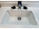 Close-up of a modern bathroom sink with a unique black faucet and running water at 2423 E 13Th St, Indianapolis, IN 46201