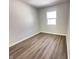 Empty bedroom with neutral walls, modern flooring, and natural light from a window at 2423 E 13Th St, Indianapolis, IN 46201