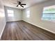 A spacious bedroom with three windows, neutral walls, and modern flooring at 2423 E 13Th St, Indianapolis, IN 46201