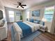 Staged bedroom with calming blue accents, plush bedding, and natural light from multiple windows at 2423 E 13Th St, Indianapolis, IN 46201