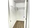 Clean white closet with wood floors, wire shelving, and door ajar at 2423 E 13Th St, Indianapolis, IN 46201