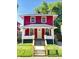 Charming red two-story home with a welcoming front porch and well-maintained lawn at 2423 E 13Th St, Indianapolis, IN 46201