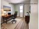 This virtually staged bedroom is shown as a home office with a desk, chair, and decor at 2423 E 13Th St, Indianapolis, IN 46201