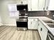 Modern kitchen with white cabinets, stainless steel appliances, and stylish backsplash at 2423 E 13Th St, Indianapolis, IN 46201