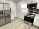Well-equipped kitchen featuring stainless steel appliances, granite counters, and white cabinets at 2423 E 13Th St, Indianapolis, IN 46201