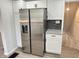 Kitchen with stainless steel refrigerator and white cabinets paired with dark hardware at 2423 E 13Th St, Indianapolis, IN 46201