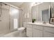 Well-lit bathroom with a tiled shower, framed mirror, and vanity with storage at 246 Legends Creek Way # Apt 207, Indianapolis, IN 46229