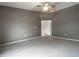 Neutral bedroom with a ceiling fan and view into the next room at 246 Legends Creek Way # Apt 207, Indianapolis, IN 46229